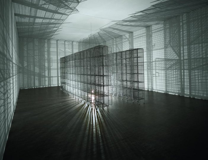 Mona Hatoum Light Sentence Mesh locker installation with a light placed in the middle to create mesh shadows on the gallery walls
