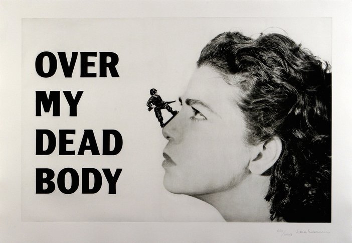 Mona Hatoum Over my dead body 1988-2002 A poster image in black and white shows a womans profile with an army figure sat on her nose. The text says 'Over my dead body' in black capital letters