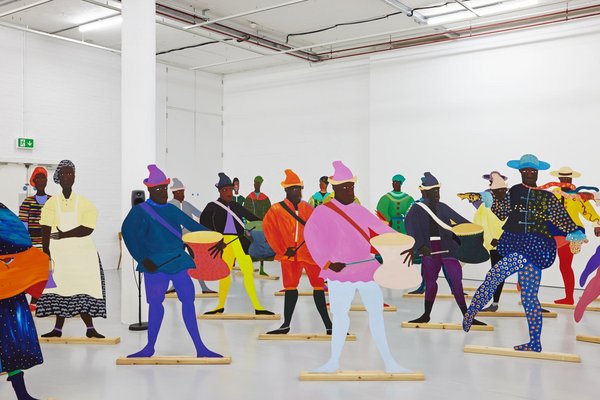 Lubaina Himid 'Naming the Money' 2004 a series of colourful cut out figures are places in a white walled gallery space