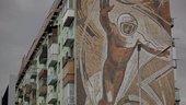 Vidokle film still of a mural on a building 