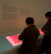 Visitors to Tate Modern looking at interpretative material relating to Mark Rothko’s Seagram Murals 1958–9