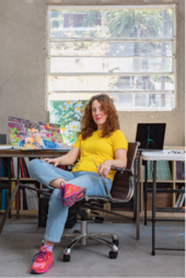 Aliza Nisenbaum sitting in her studio