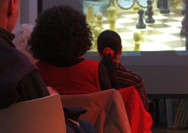 Visitors sitting and watching a film screening