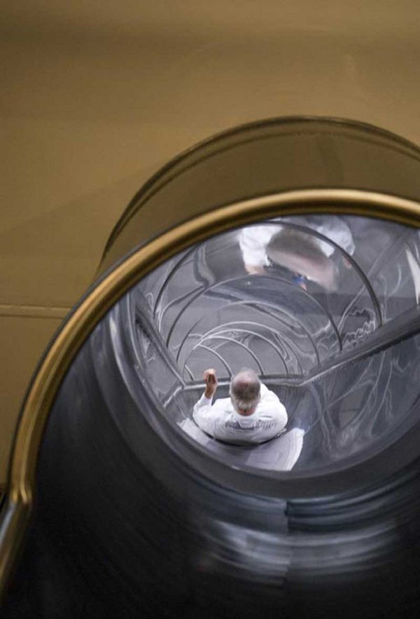 View showing a man in descent inside one of the slides from Carsten Höller Test Site at Tate Modern.