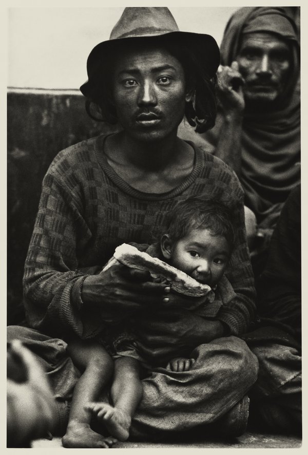 Don McCullin, Strange travellers-a destitute Tibetan family in the booking hall of railway station at dawn, Delhi 1965 Â© Don McCullin