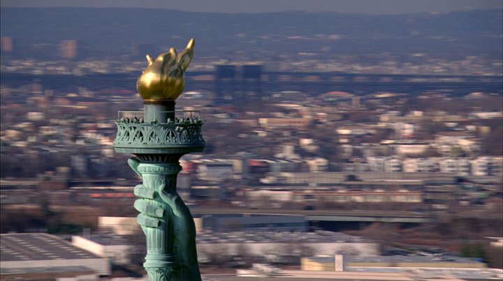 Still from McQueen film showing the torch of the statue of Liberty