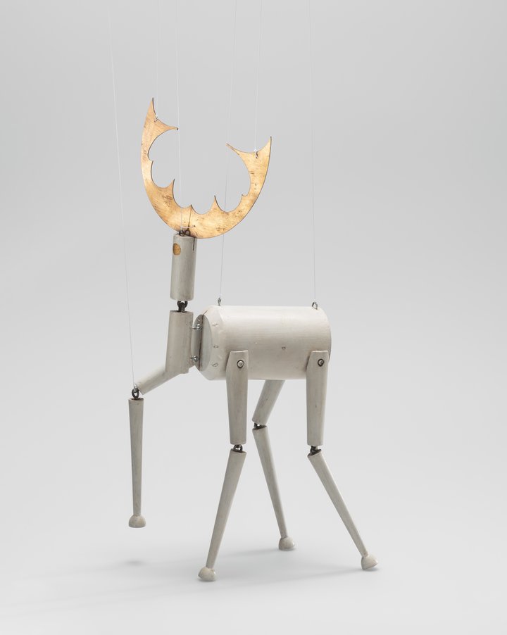 A puppet made of wood in the form of a deer 